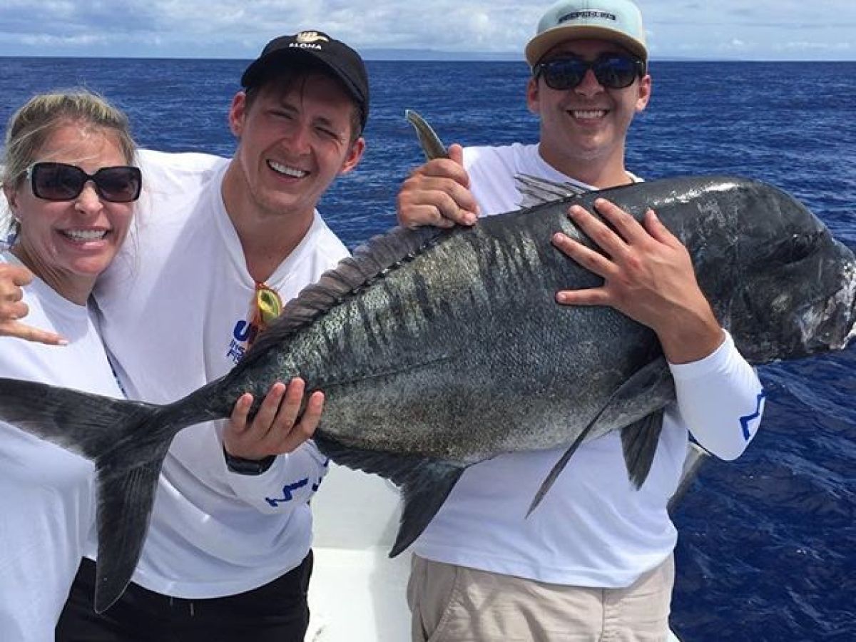 a person holding a fish in the water