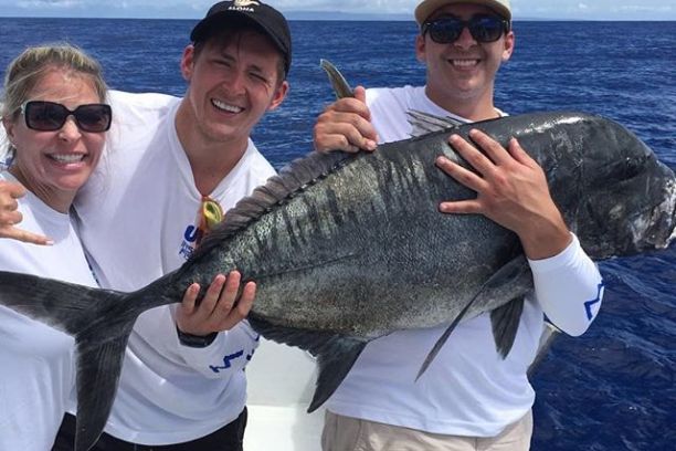 a person holding a fish in the water