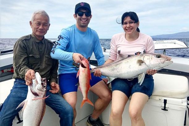 a woman holding a fish