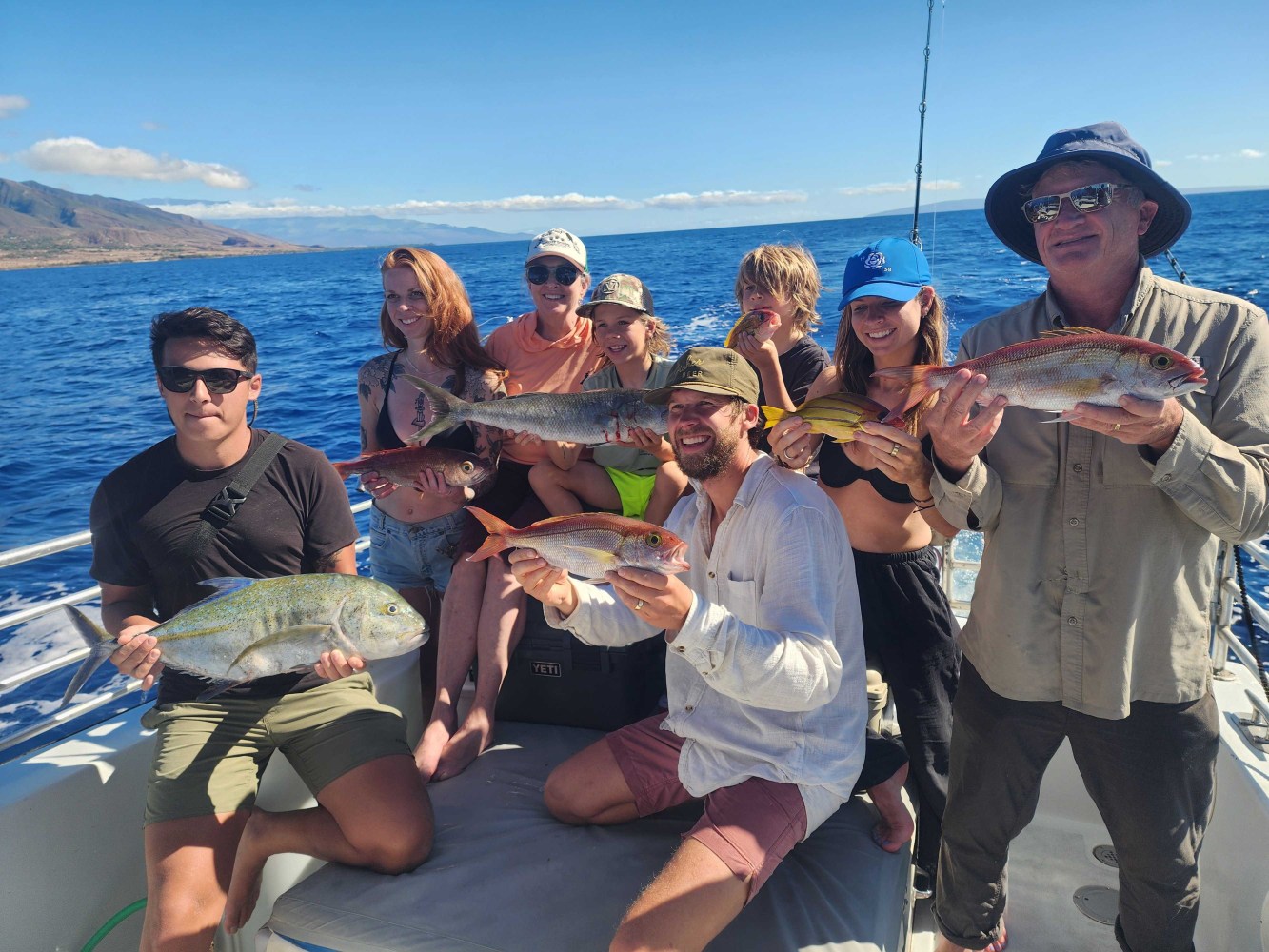a group of people standing next to a body of water