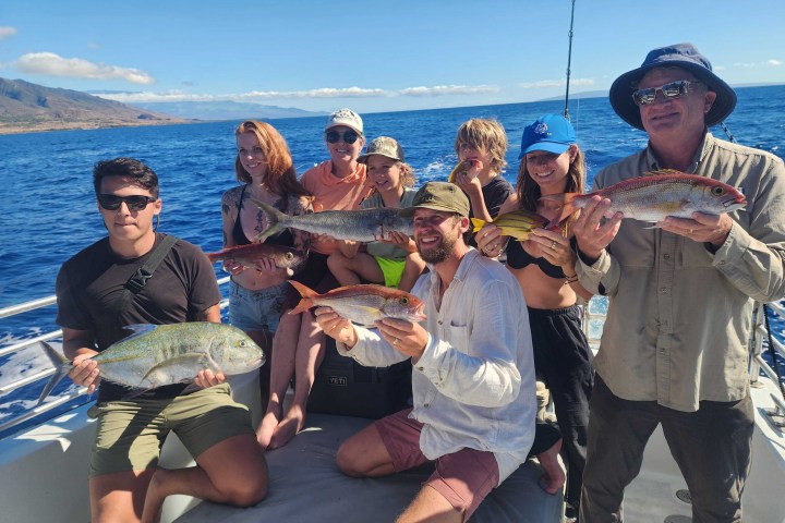 a group of people standing next to a body of water