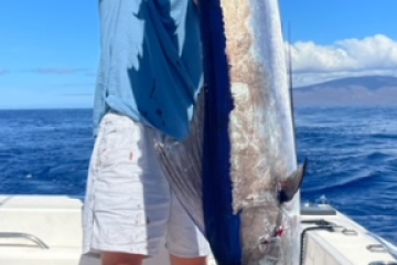 a person holding a fish in the water